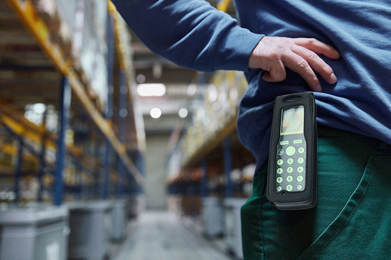 Warehouse worker with Spectralink terminal on belt
