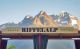 Sign reading "Riffelalp" in front of a beautiful mountain scenery